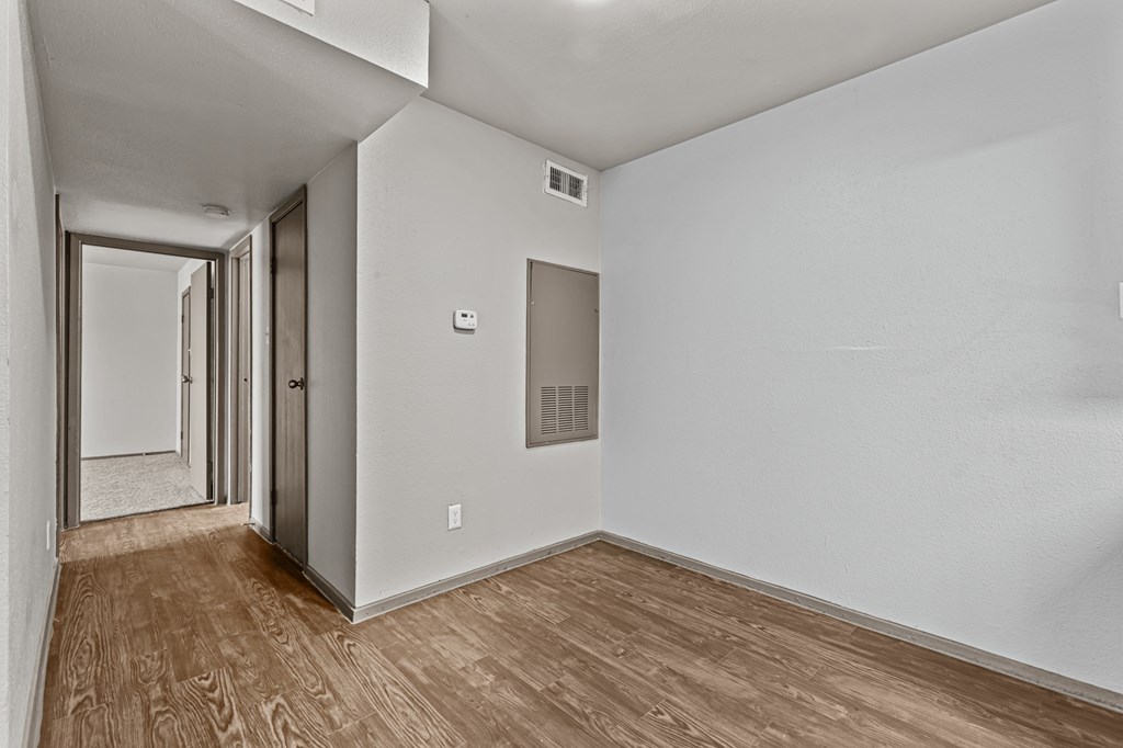 A long hallway with wood floors and white walls.at Rock 35, Round Rock, 78681