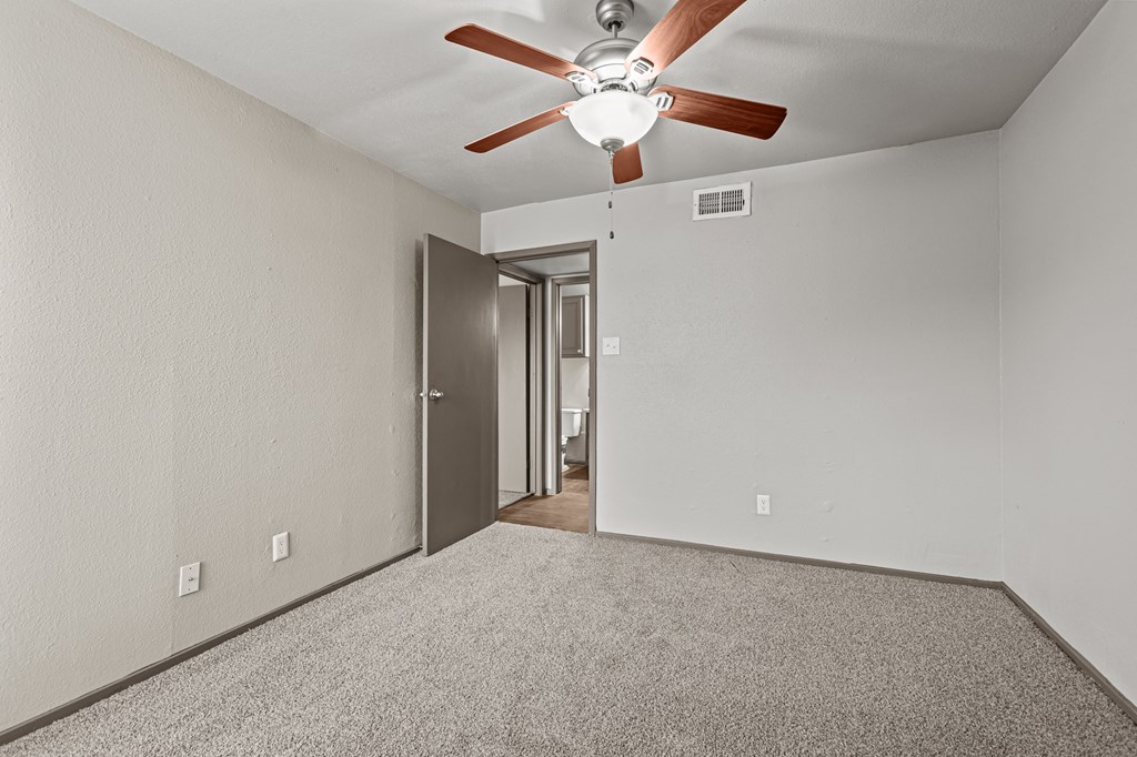 A room with a ceiling fan and a door.at Rock 35, Round Rock, TX, 78681