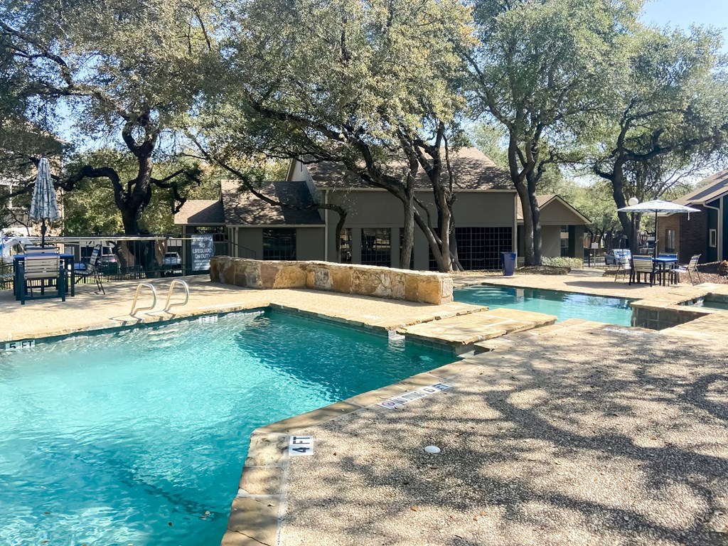 a resort style pool with a diving board in the middle of it  at Carmel at Deerfield, Texas