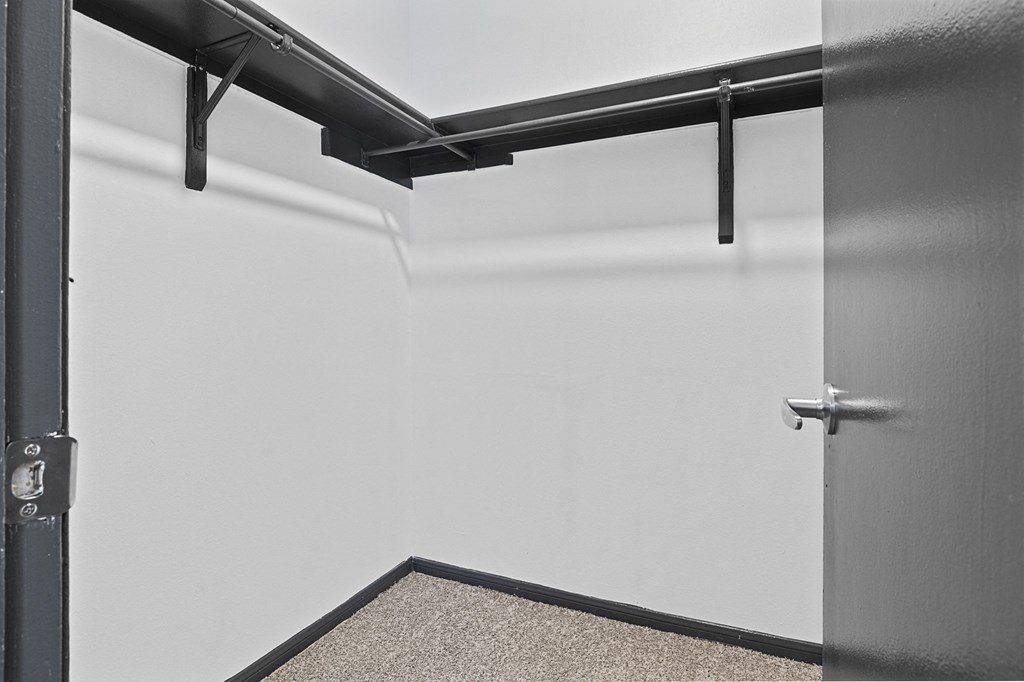 an empty room with a white wall and a door at Tradewinds, Windcrest