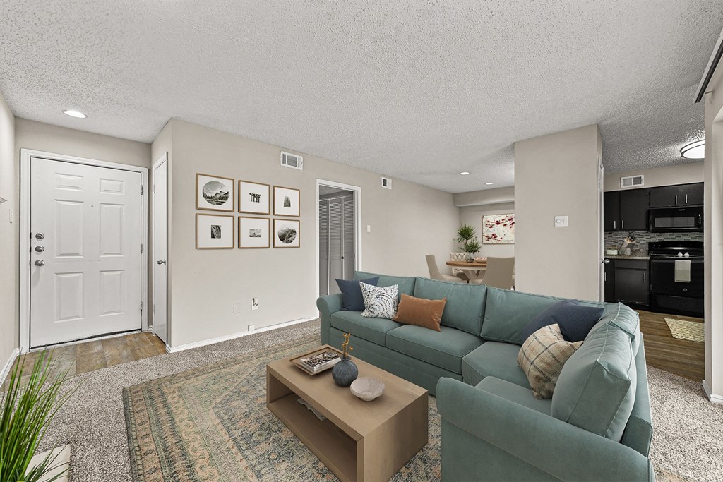 a living room with a blue couch and a coffee table