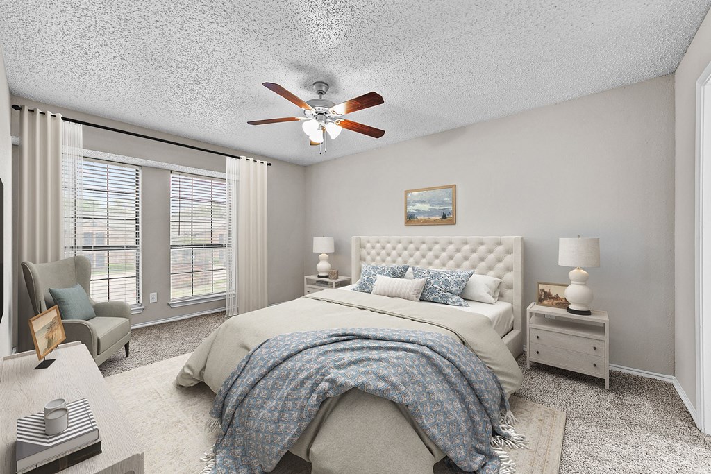 a bedroom with a large bed and a ceiling fan