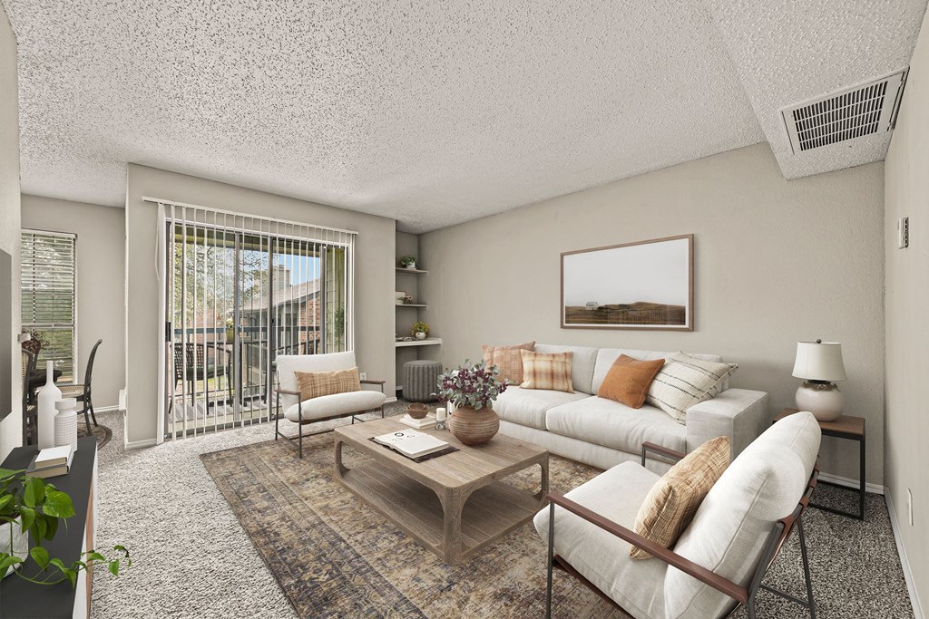 a living room with a white couch and a coffee table at Legacy Apartments in Plano, TX