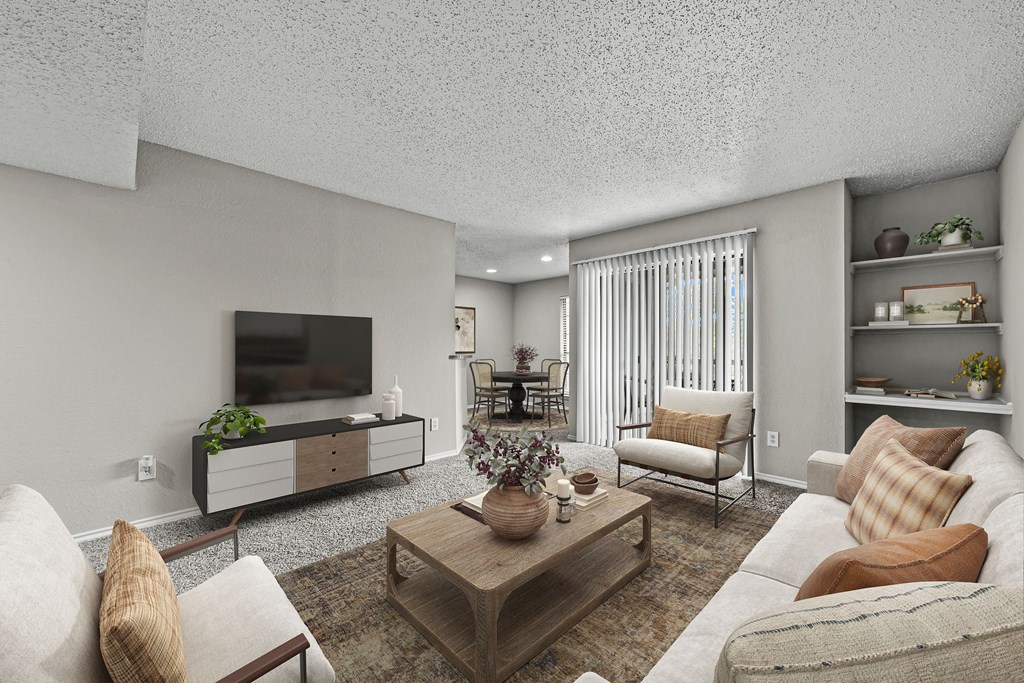 Living room with furniture and a television at Legacy Apartments in Plano, TX