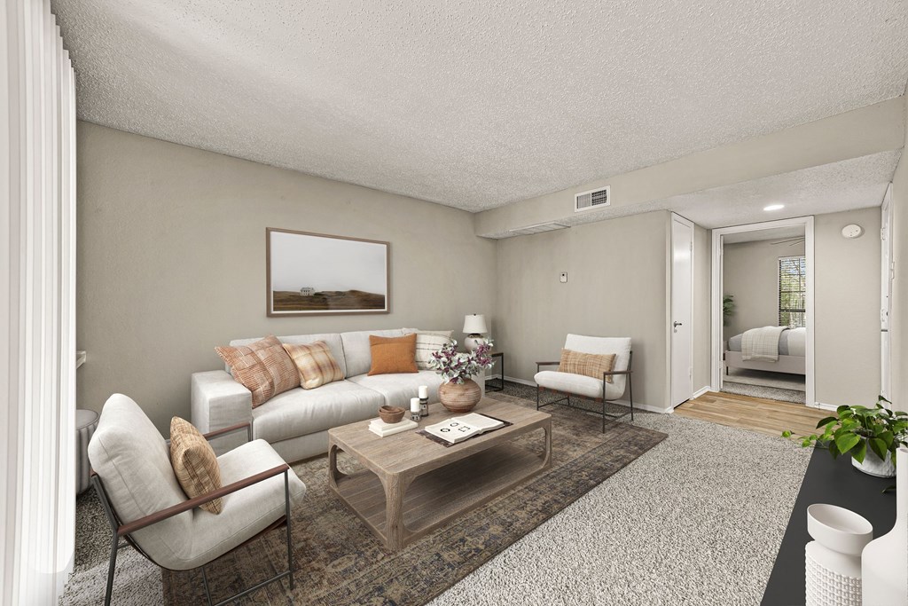the living room of an apartment with a couch and a table at Legacy Apartments in Plano, TX