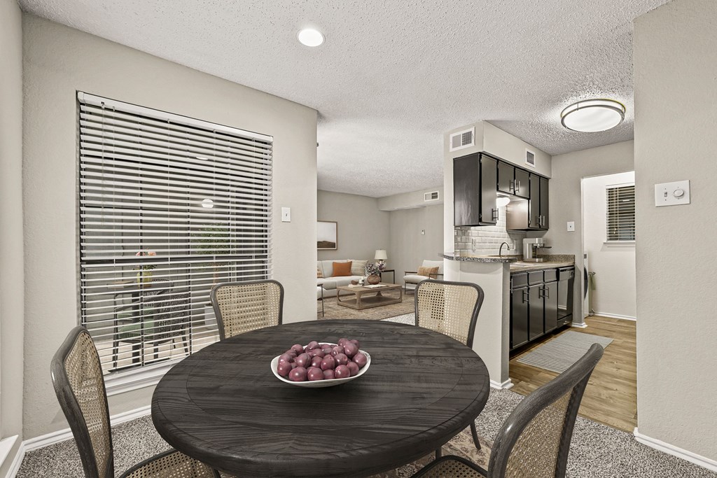 a dining room table with a bowl of fruit on it at Legacy Apartments in Plano, TX