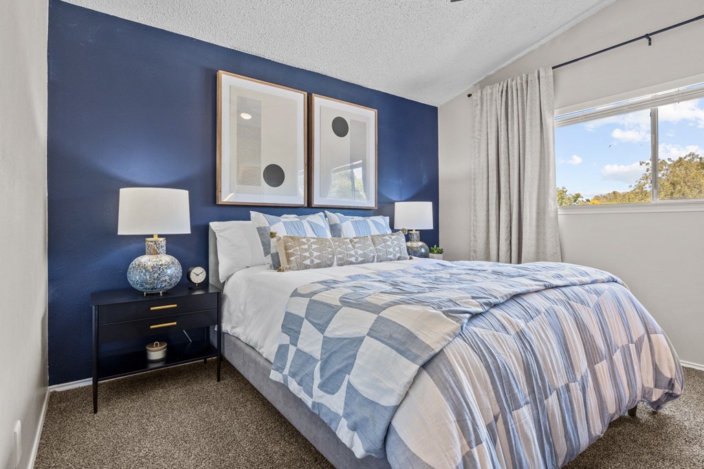 Bedroom with cozy bed and frames at Maxwell Townhomes, San Antonio, TX