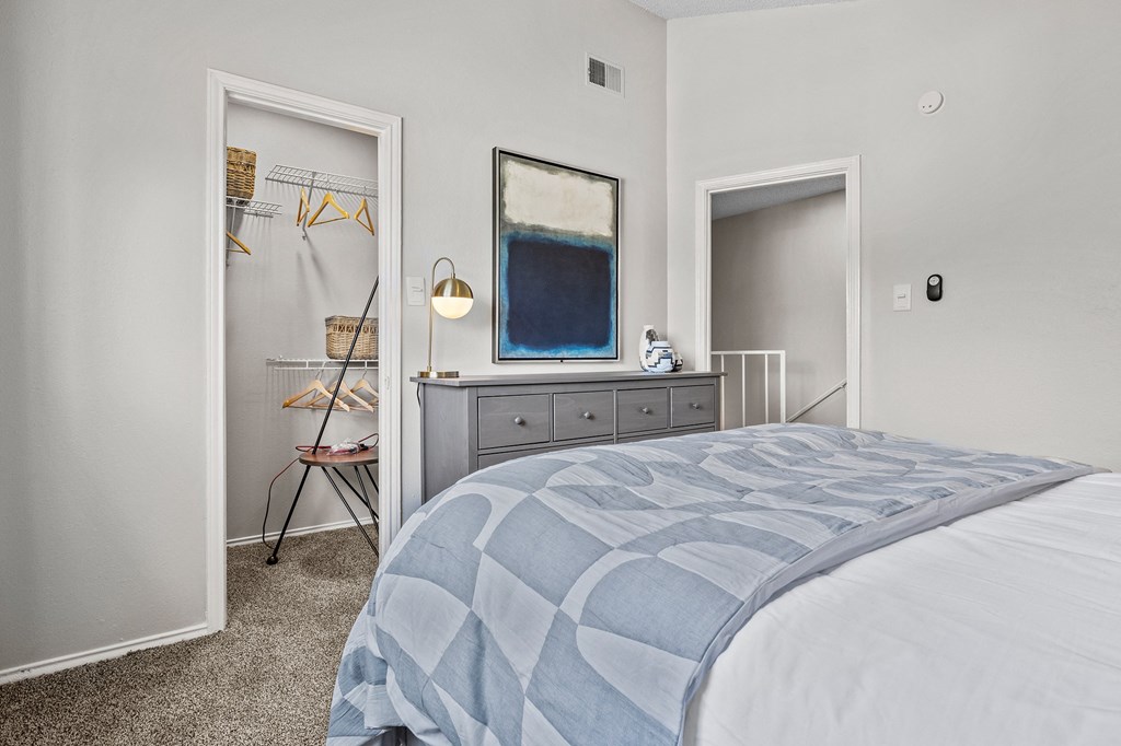 Bedroom with cozy bed and mirror at Maxwell Townhomes, San Antonio, Texas