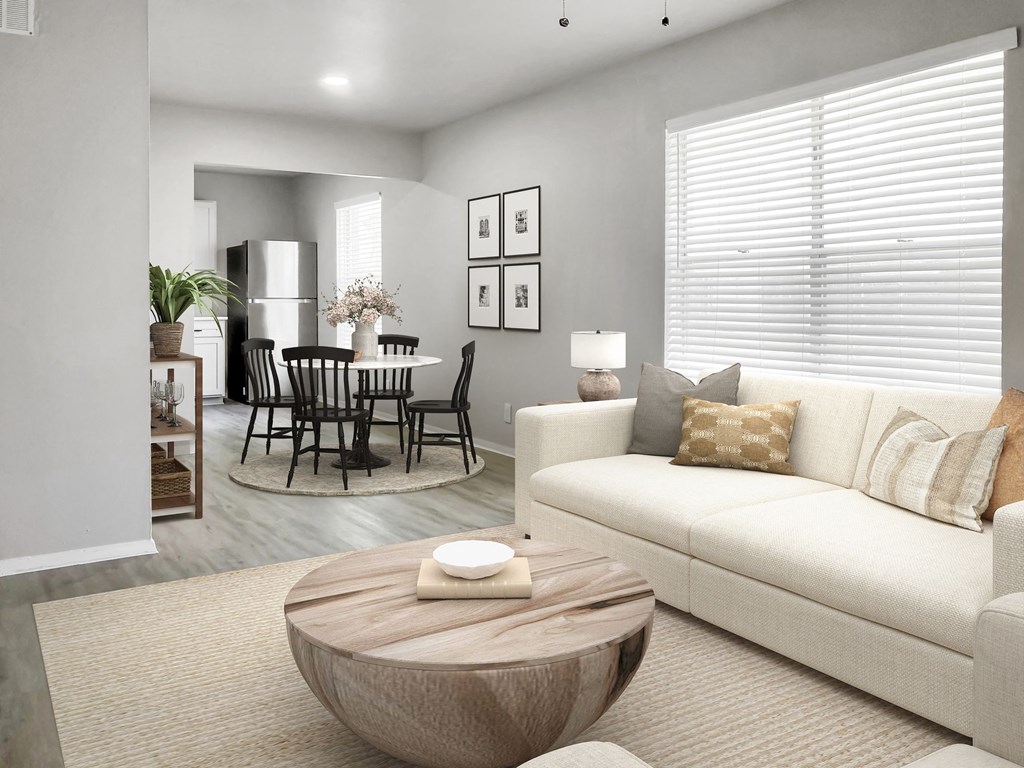 a living room with a couch and a coffee table in front of a dining room table  at Sunset Heights, Texas