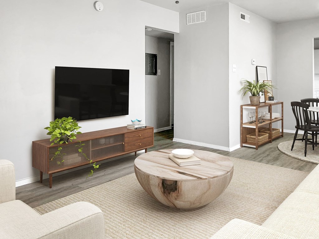 a living room with a large tv on the wall and a coffee table in the middle of  at Sunset Heights, Texas