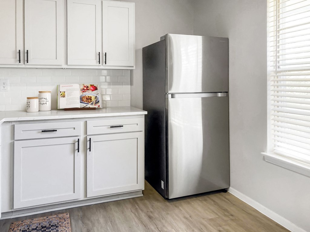 a kitchen with white cabinets and a stainless steel refrigerator  at Sunset Heights, Texas, 78209