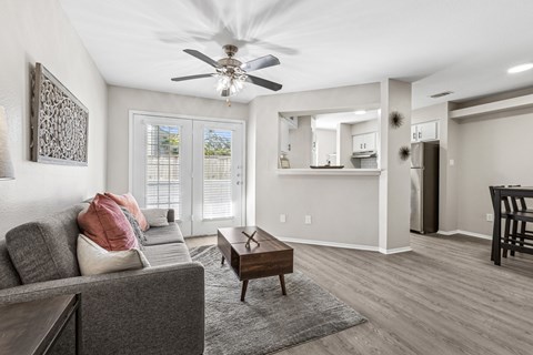 A living room with a grey couch and a wooden coffee table.
