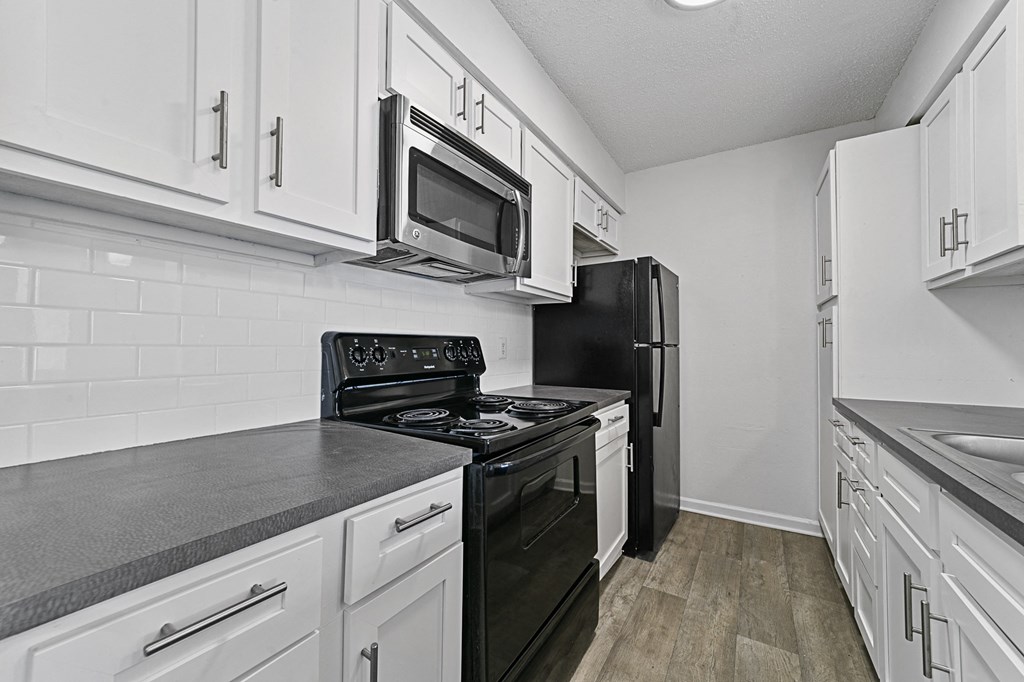kitchen with white cabinets and black appliances at Vesper, Texas, 75254