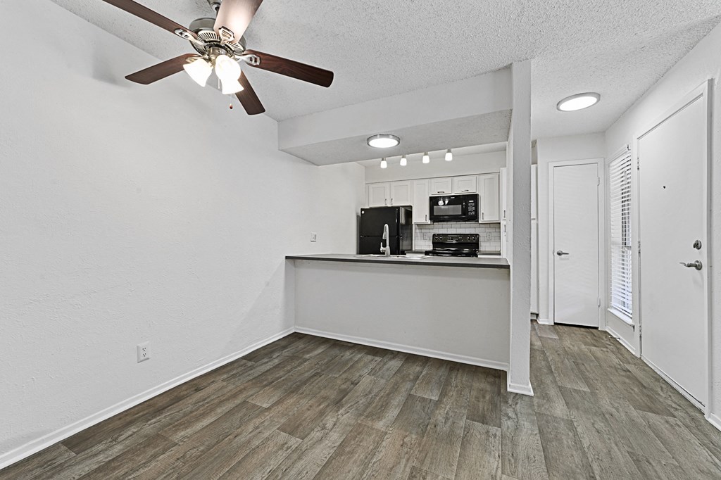 a kitchen and living room with a ceiling fan at Vesper, Dallas, Texas