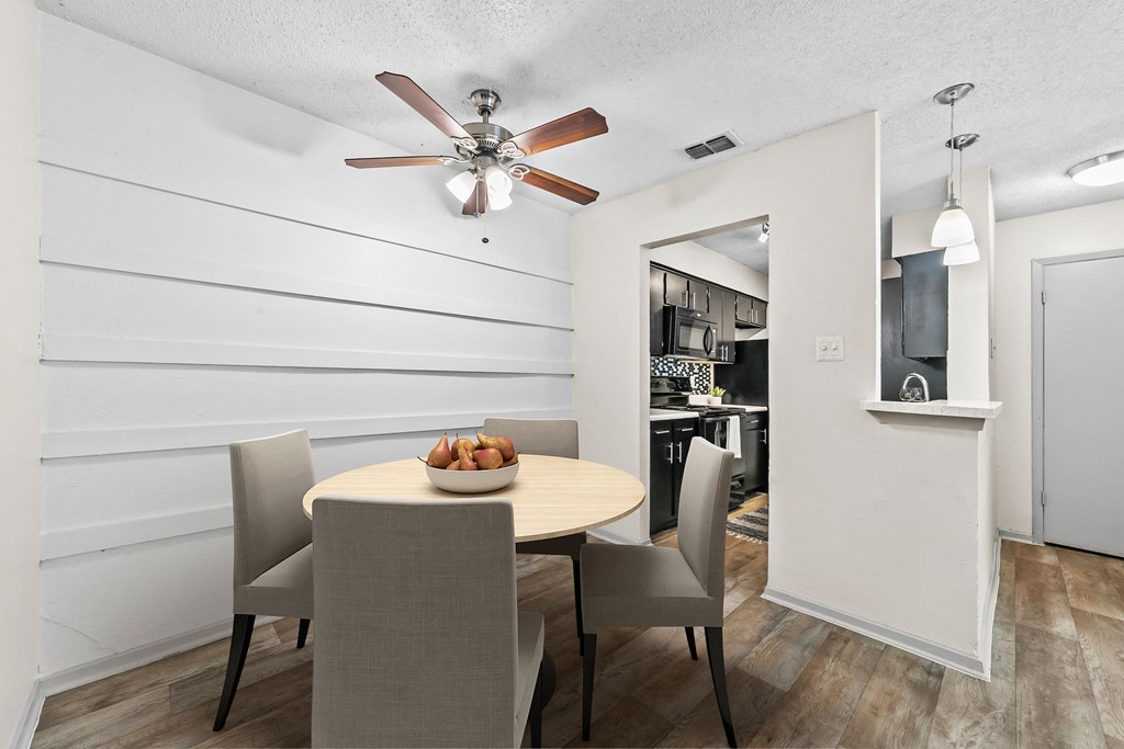 a dining area with a table and chairs and a ceiling fan  at Vesper, Dallas, Texas