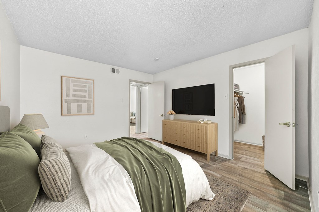 a bedroom with a bed and a dresser  at Vesper, Dallas