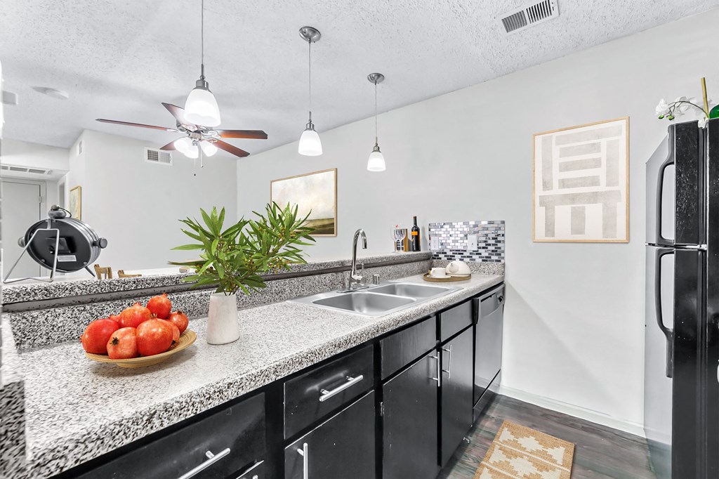 a kitchen with a sink and a refrigerator  at Vesper, Dallas, 75254