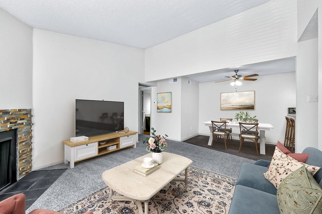 a living room with a fireplace and a tv  at Vesper, Dallas, Texas