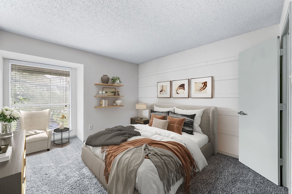 a bedroom with a bed and a chair in front of a window  at Vesper, Texas
