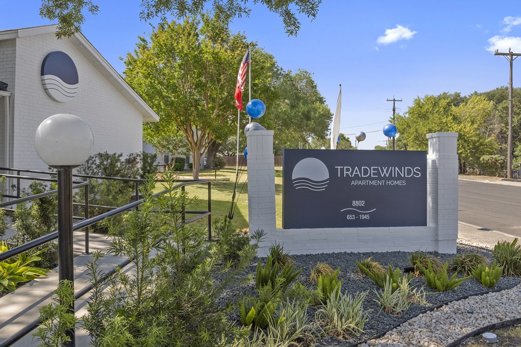 a sign that says tradewinds cores in front of a building