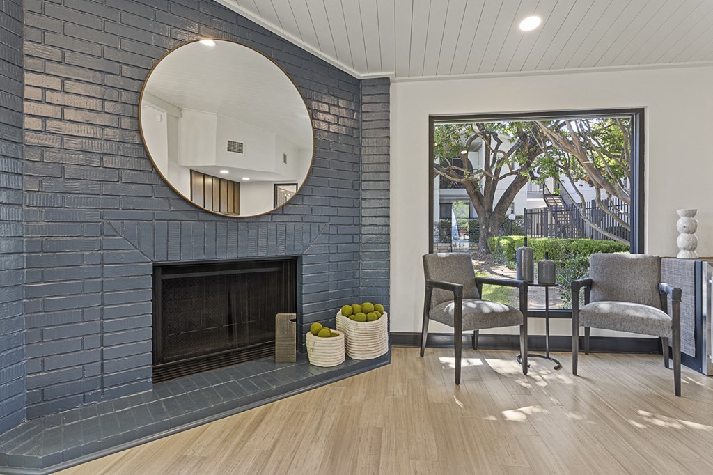 A living room with a fireplace and a mirror above it. at Tradewinds, Windcrest, TX