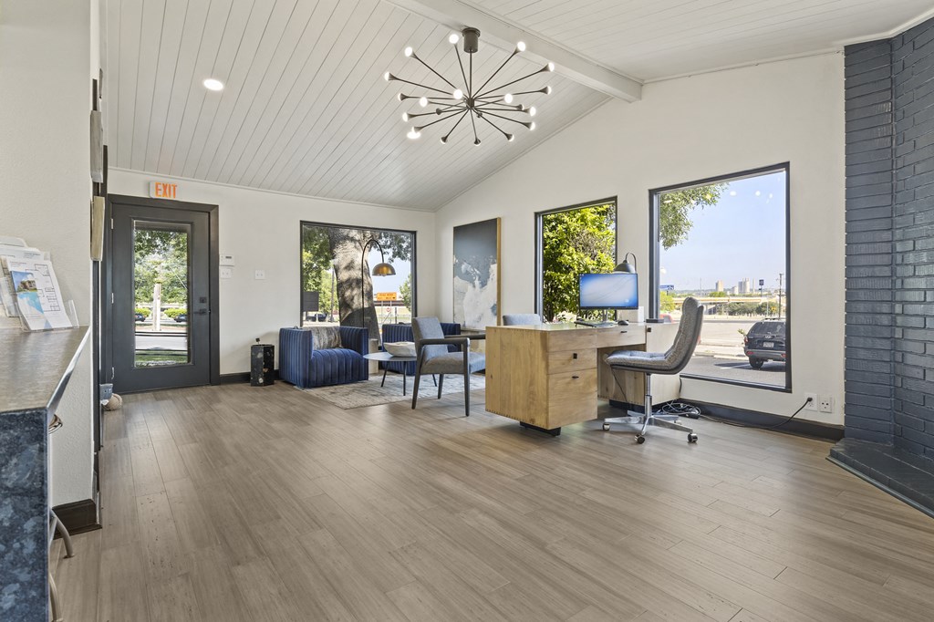 A room with a wooden floor and a ceiling light fixture. at Tradewinds, Windcrest