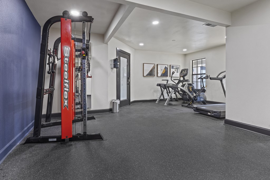 the gym at the knightsbridge apartments facility with weights and cardio equipment