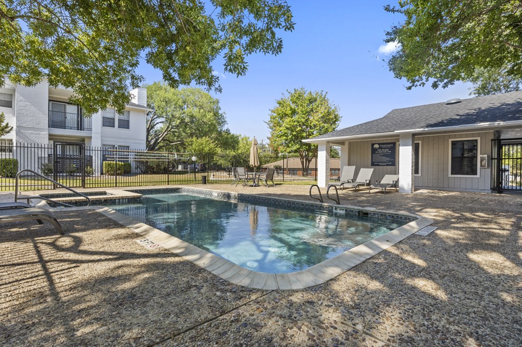 a swimming pool with a house in the background
