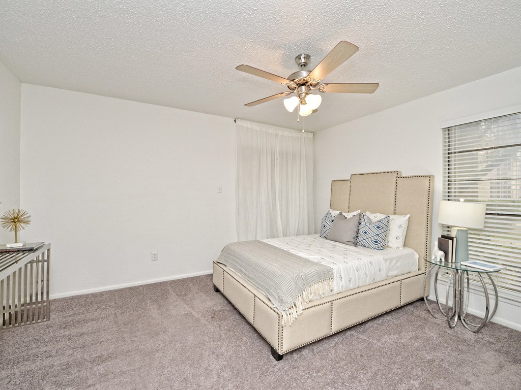 a bedroom with a bed and a ceiling fan at Peaks at Northwest Hills Apartments, Austin