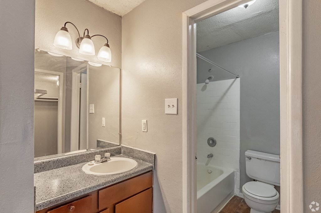 a bathroom with a sink and a toilet at The Frederick, San Antonio, TX 78240