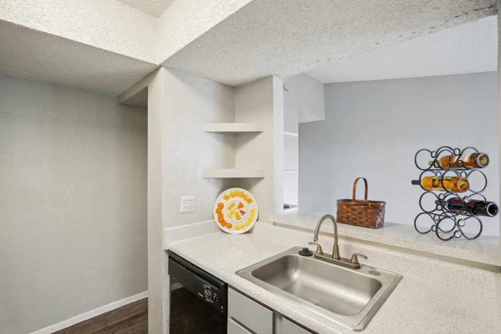 The Keller apartment kitchen with stainless steel sink and black dishwasher