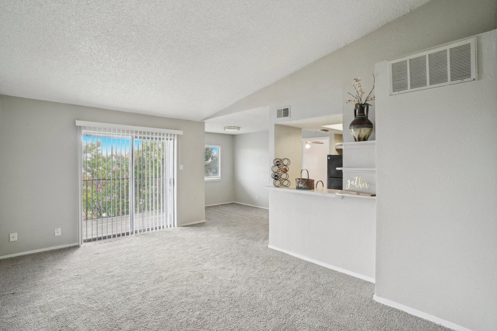 a living room with a door to a balcony