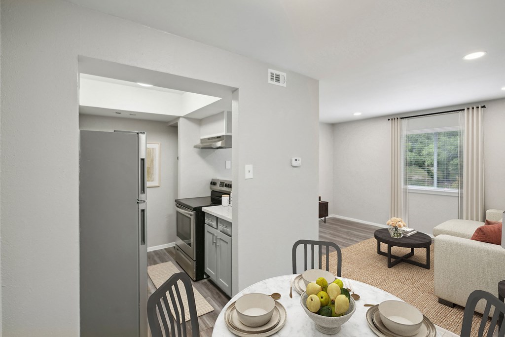 a kitchen and living room with a table and chairs
