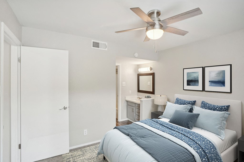 a bedroom with a bed and a ceiling fan