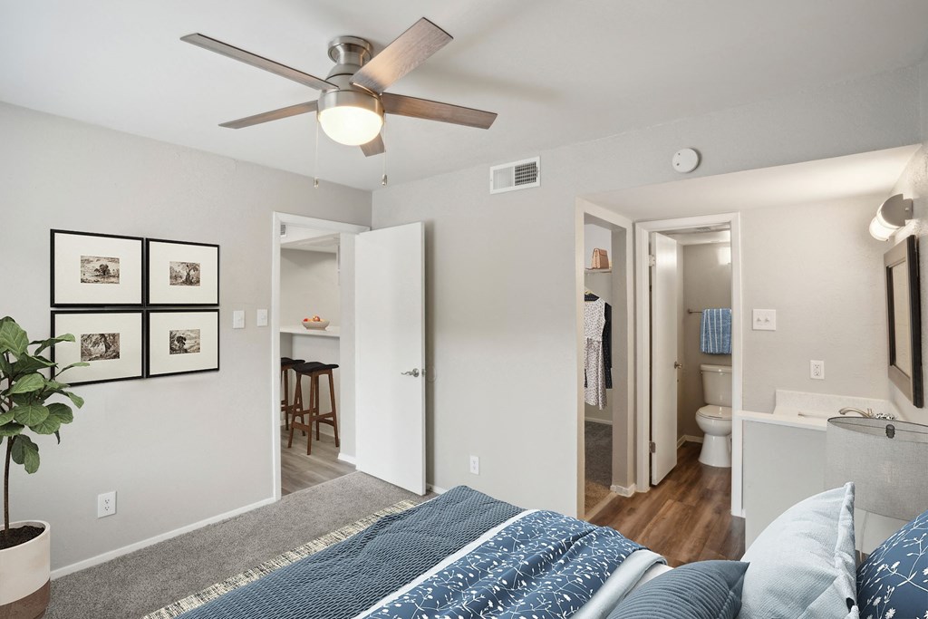 a view of a bedroom with a bed, bathroom and walk-in closet