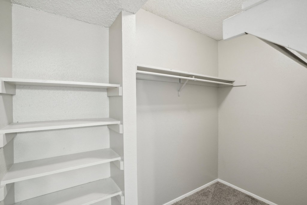 an walk-in closet with shelves