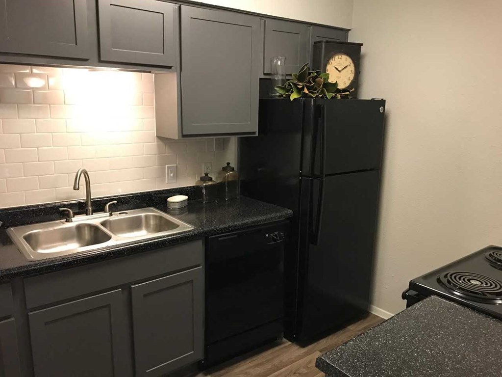 a kitchen with a sink and a refrigerator