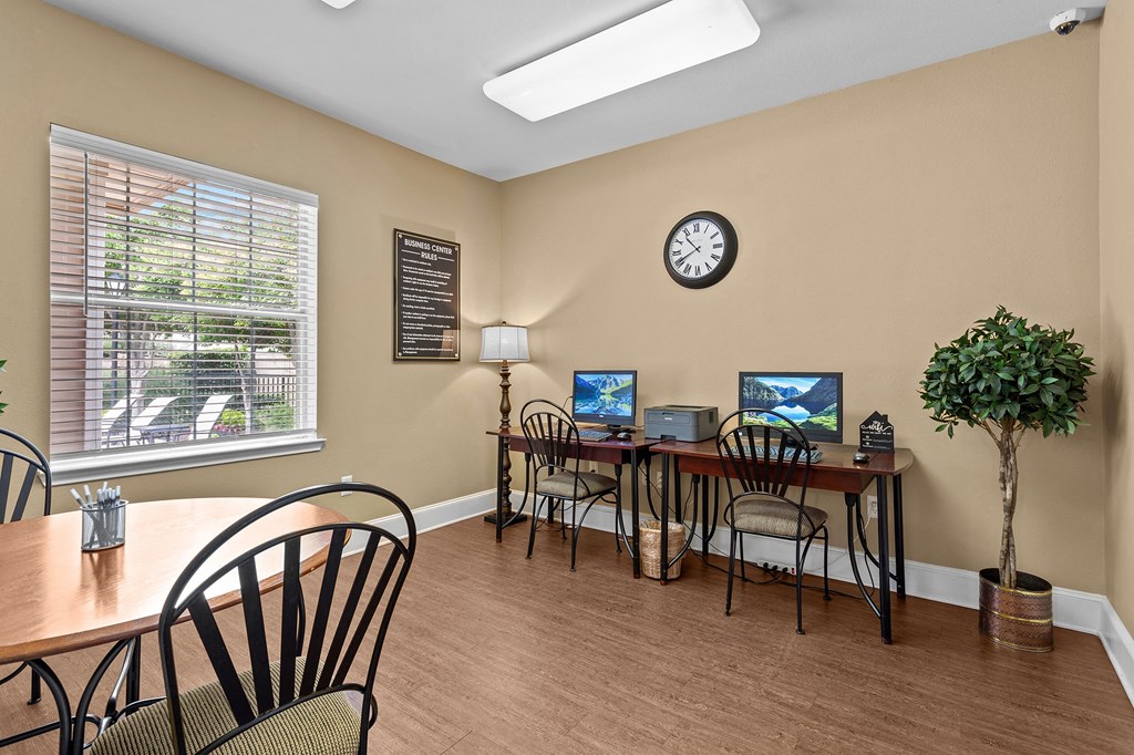 a conference room with a table and chairs and a clock on the wall at Southgate Glen, Weatherford