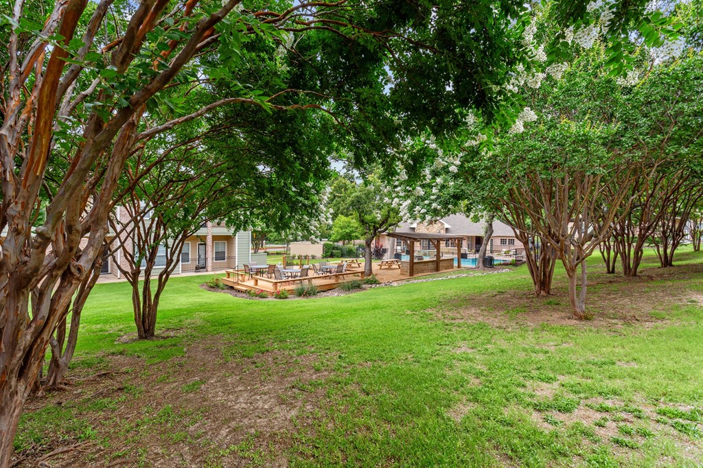 a yard with trees and houses in the background at Southgate Glen, Weatherford, 76086