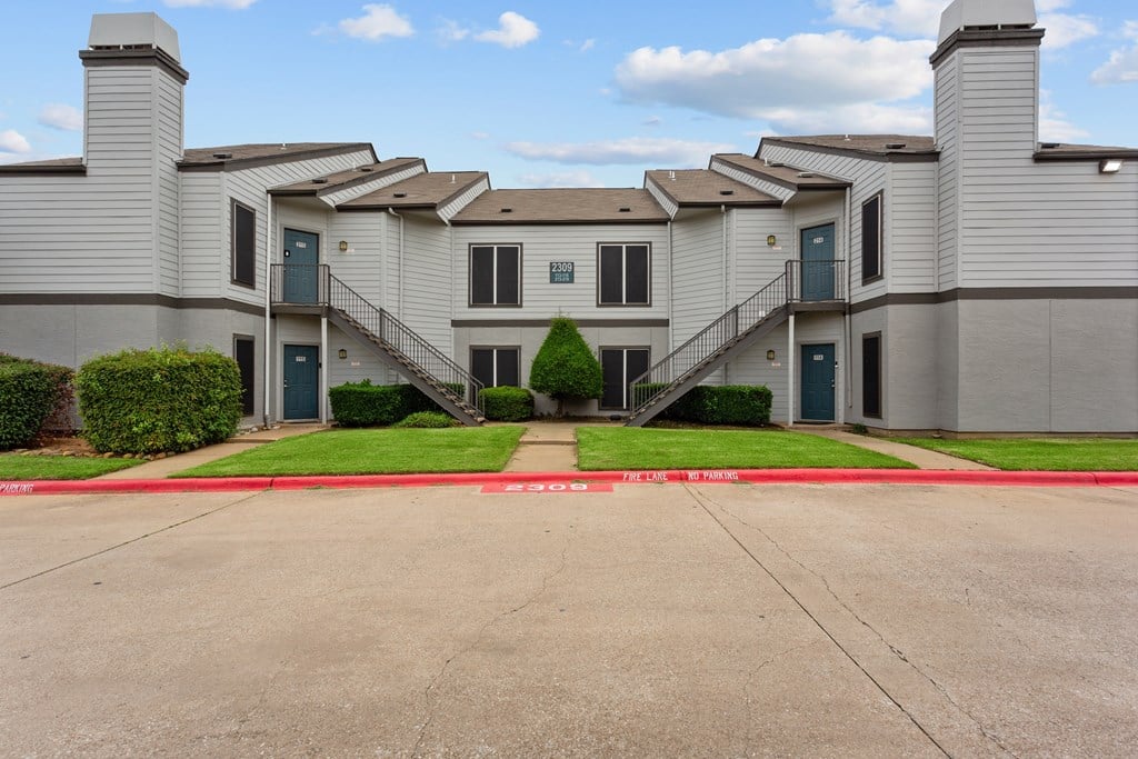 A large building with a red line painted on the ground in front of it.