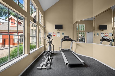 A gym with treadmills and exercise bikes.