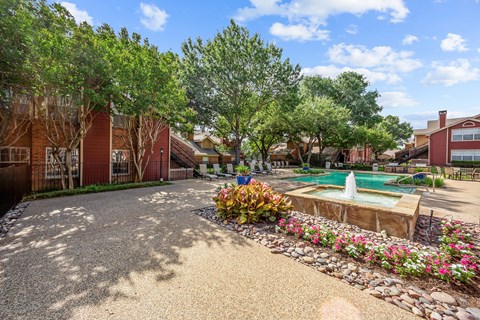 A residential area with a pool and a garden.