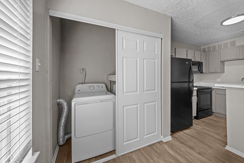 A laundry room with a washer and dryer in it.