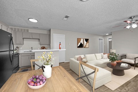 A modern kitchen with a black refrigerator and a dining table with a bowl of fruit on it.