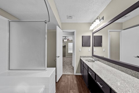 A bathroom with a white tub and sink.