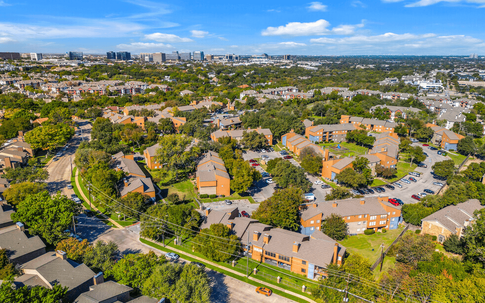 A bird's eye view of a residential area with houses and trees.