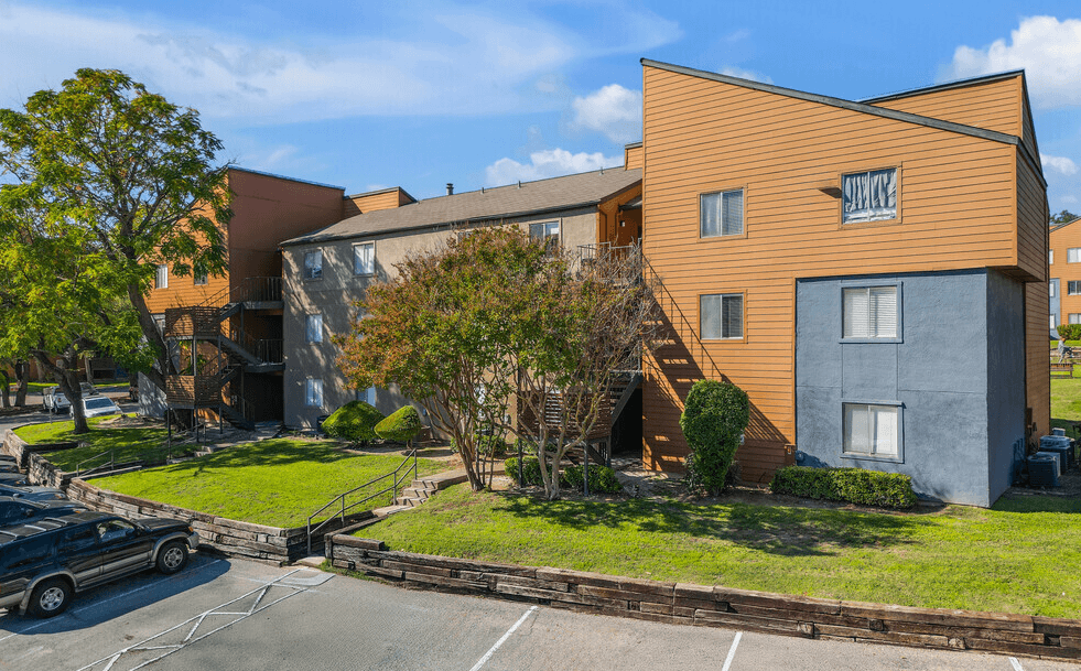 A modern building with a car parked in front.