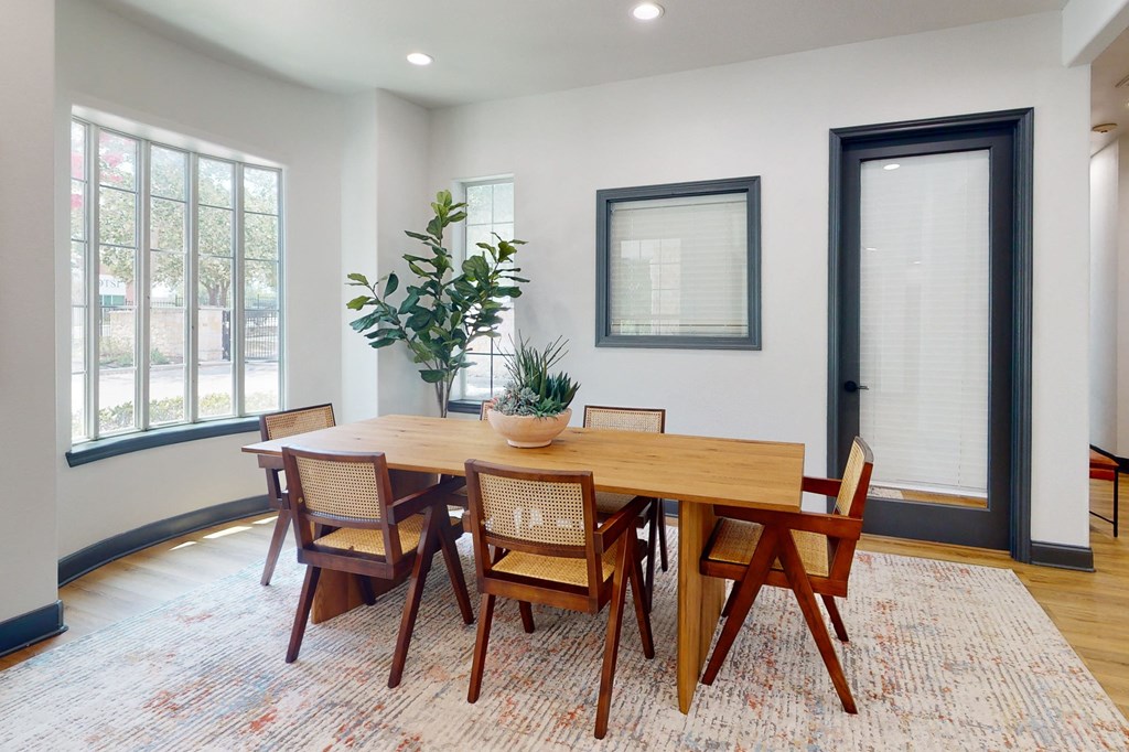 a dining room with a wooden table and chairs a dining room with a wooden table and chairs at Remington Ranch, San Antonio, TX, 78247