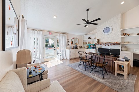 A living room with a couch, chairs, and a television.