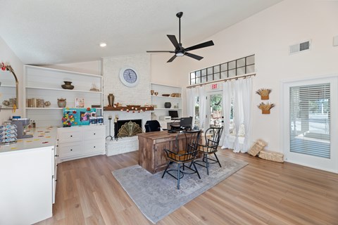 A living room with a fireplace and a dining table set up.